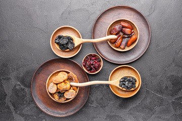 Different dried fruits on dark background