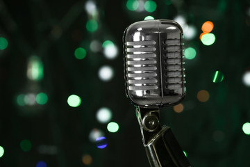 Fototapeta na wymiar Retro microphone against defocused lights