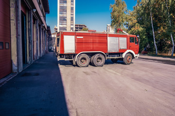 Fototapeta na wymiar Fire engine leaving the garage of the fire station