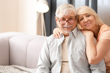 Happy mature couple resting together at home