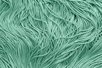 Turquoise tassels as background, closeup