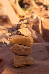Red Rock Cairn with other Red Boulders Behind It