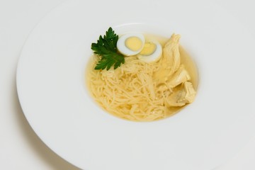 Bowl of chicken broth isolated on white background