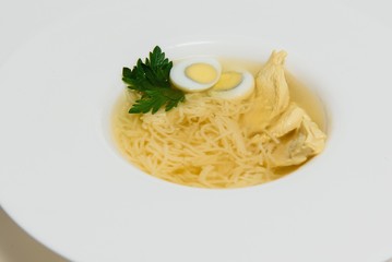 Bowl of chicken broth isolated on white background