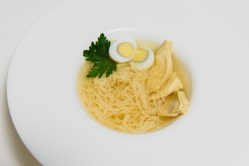 Bowl of chicken broth isolated on white background
