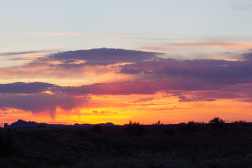 Vivid Desert Sunset with Silhouetted Landscape