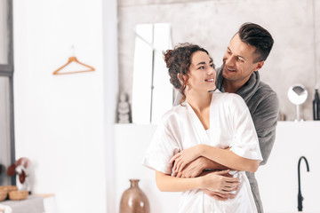 Happy young couple in bathroom at home - Powered by Adobe