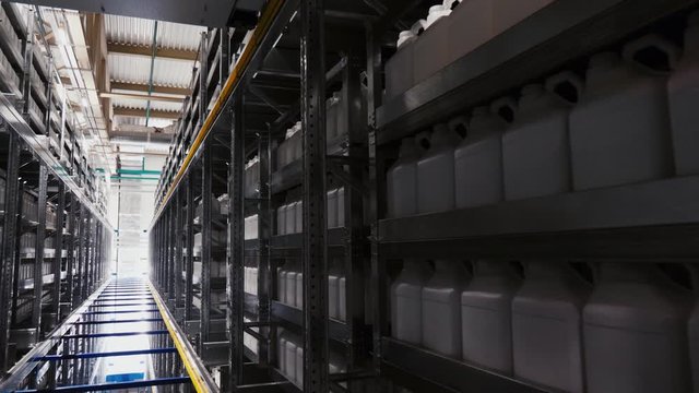 motion past canisters with chemical fertilizers in warehouse