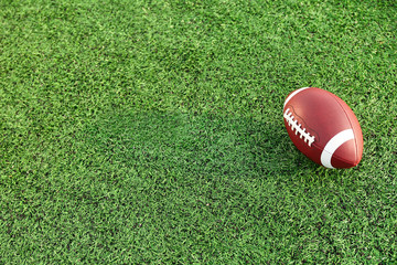 Rugby ball on green field outdoors