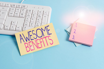Text sign showing Awesome Benefits. Business photo text informal an advantage or something extra such as money Paper blue desk computer keyboard office study notebook chart numbers memo