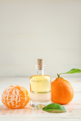 Bottle of tangerine essential oil on table