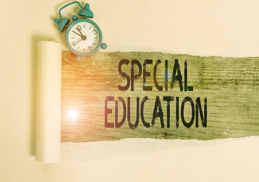 Text Sign Showing Special Education. Business Photo Showcasing Form Of Learning Given To Students With Mental Challenges Alarm Clock And Torn Cardboard Placed Above A Wooden Classic Table Backdrop