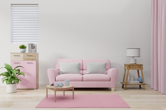 The pink sofa in the living room wall color white.
