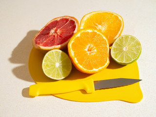 citrus fruits on a lemon shaped chopping board
