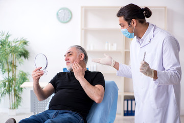 Old man visiting young doctor for plastic surgery