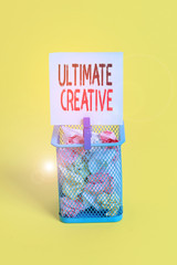 Conceptual hand writing showing Ultimate Creative. Concept meaning way of producing or using original and unusual ideas Trash bin crumpled paper clothespin office supplies yellow