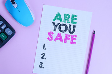 Text sign showing Are You Safe. Business photo text Free from danger Not anticipating any Harm Hurt physically Electronic calculator wire mouse striped sheet pencil colored background