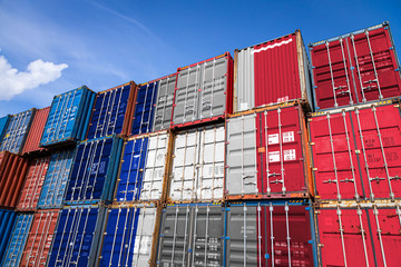 The national flag of France on a large number of metal containers for storing goods stacked in rows on top of each other. Conception of storage of goods by importers, exporters