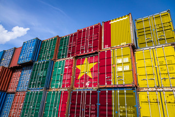 The national flag of Cameroon on a large number of metal containers for storing goods stacked in...