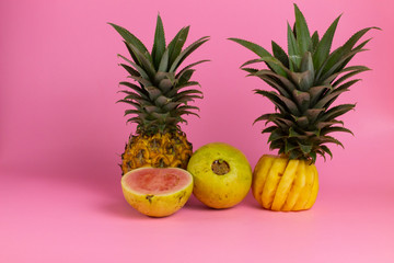 exotic tropical fruits, pineapple  isolated on a pink background