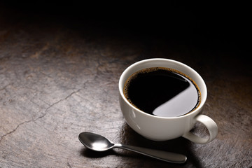 Cup of coffee with copy space on rustic background