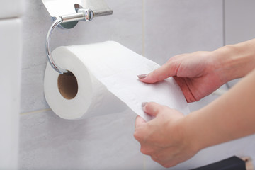 Close-up of in Hand using a toilet paper.