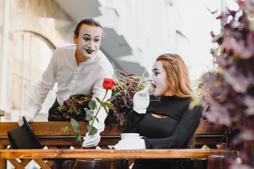 Male mime giving a flower to female mime