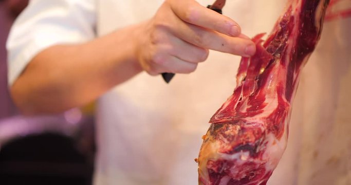 slicing Jamon, Pata Negra in a market, Mercado, Spanish Ham