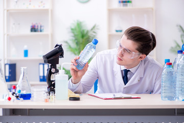 Young male chemist experimenting in lab