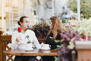 A couple of merry mimes. He hurries on a date.