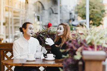 Male mime giving a flower to female mime