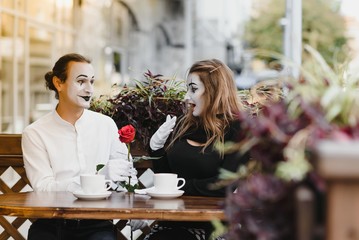 Male mime giving a flower to female mime
