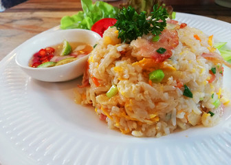 Delicious Fried rice bacon with vegetables and fried eggs white dish