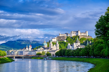 A view of the Austrian city of Salzburg along the Salzach River. - obrazy, fototapety, plakaty