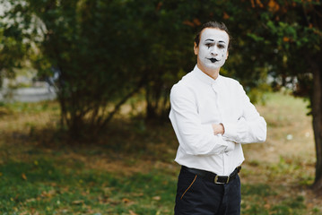 Portrait of a man, artist,clown, MIME. Shows something. Mime actor shows different emotions.
