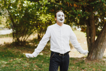 young Funny mime shows something.