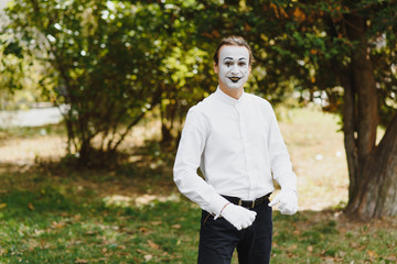 Portrait of a man, artist,clown, MIME. Shows something. Mime actor shows different emotions.