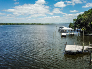 Aerial shot of multiple boat docks on the river