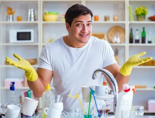 Man enjoying dish washing chores at home