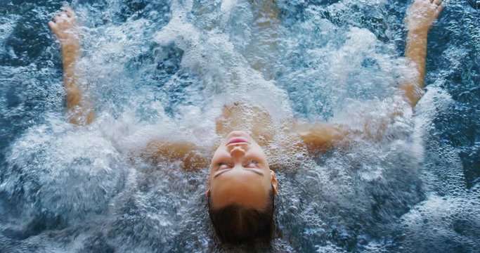 Close up of an young female is enjoying and having relax in a bath tube in a luxury wellness center.
