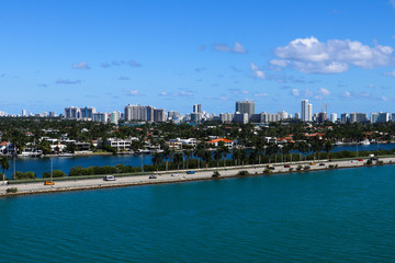 The MacArthur Causeway with Palm Island and South Beach buildings in the background in Miami, Florida.