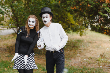 A couple of merry mimes. He hurries on a date.