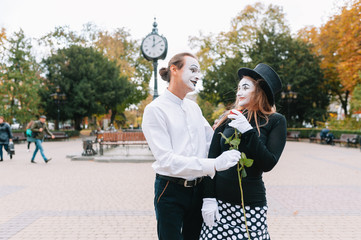 A couple of merry mimes. He hurries on a date.