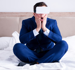 Businessman wearing a virtual reality headset in the bedroom