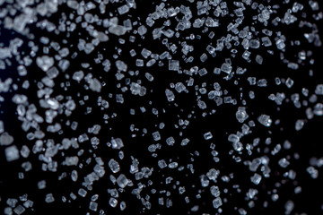 macro photography of small sugar crystals falling