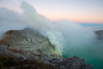 Beautiful scenery view of Kawah Ijen volcano in Java island of Indonesia at dawn. Ijen volcano complex has some of the highest levels of sulfur one of the more dangerous places on Earth.