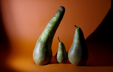 green pears on orange background