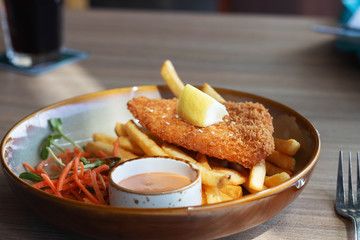 fried fish fellet wiht french fries and veggies on plate