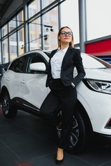 business woman buys a car at a car dealership