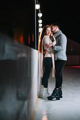 Date lovers in winter rink skates. Concept of Christmas holidays, caring for your loved one.